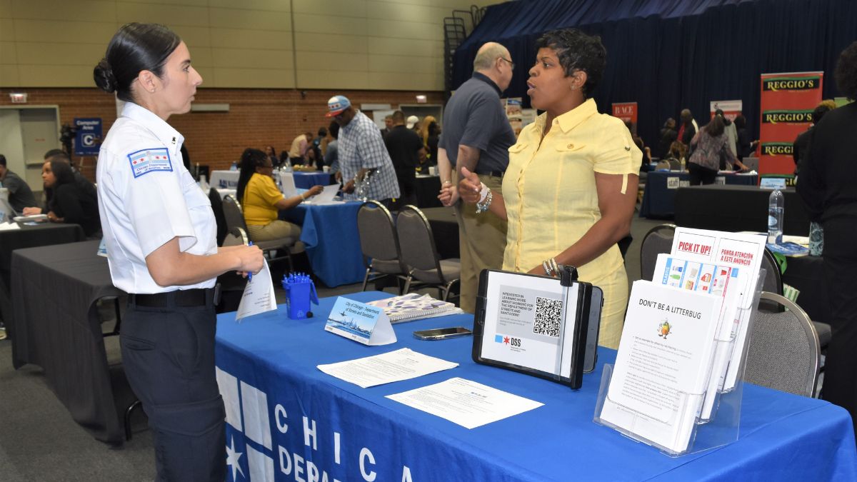 An attendee and vendor at the Airport Expo and Job Fair