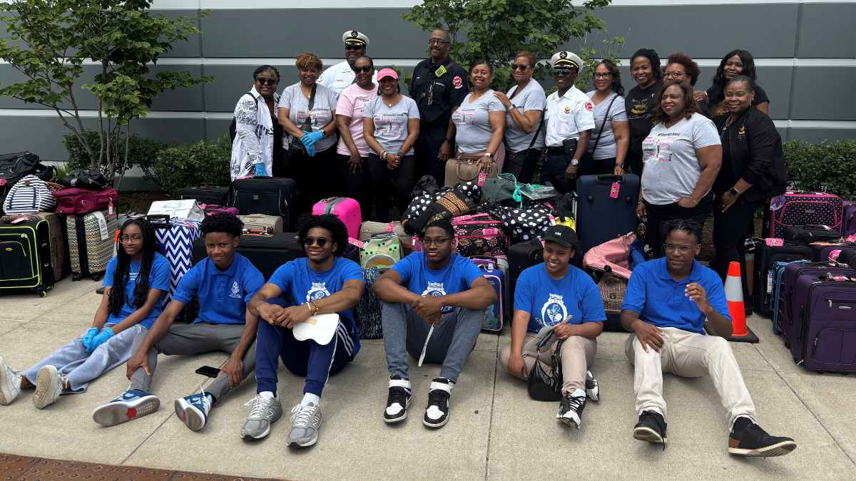Members of the Chicago Fire Department and the Will County Black Diamond Chapter of Top Ladies of Distinction, Inc. at the Hope in a Suitcase event
