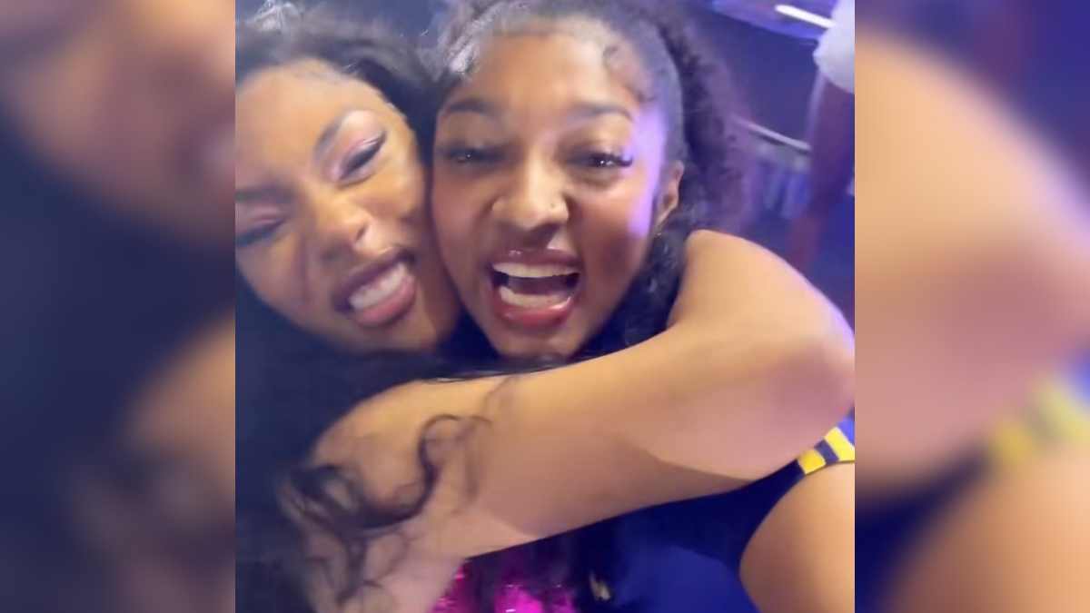 Megan Thee Stallion embraces Angel Reese during the rapper's Lollapalooza performance
