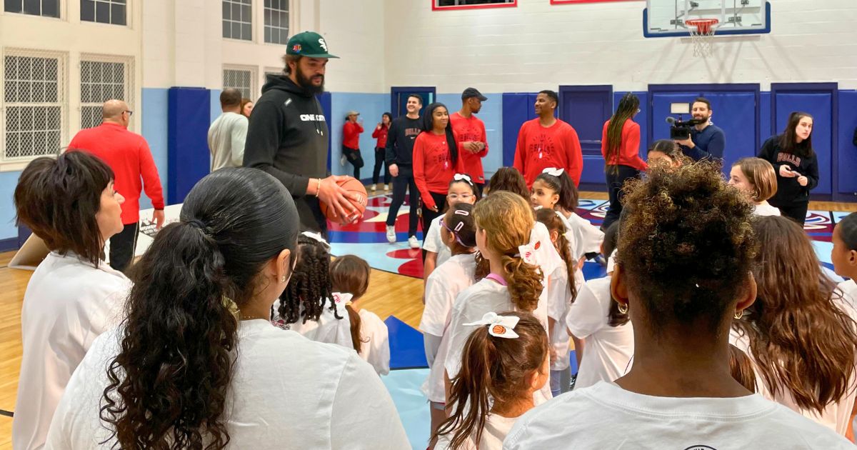 Joakim Noah huddles up with young hoopers at The Miracle Center's all-girls basketball clinic, inspiring them to dream big and believe in themselves.